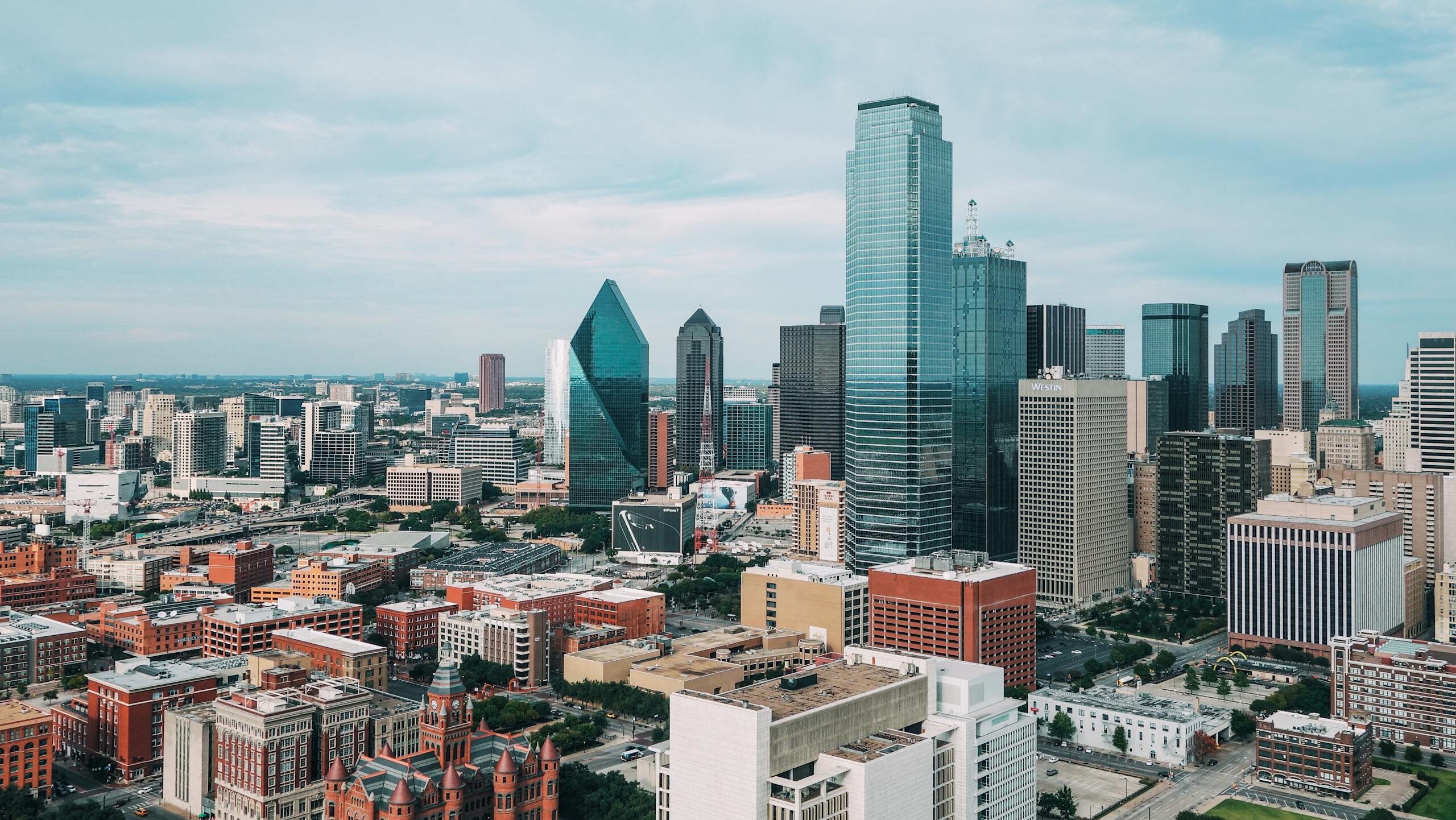 Aerial view of the vibrant Dallas skyline with iconic skyscrapers and urban landscape.